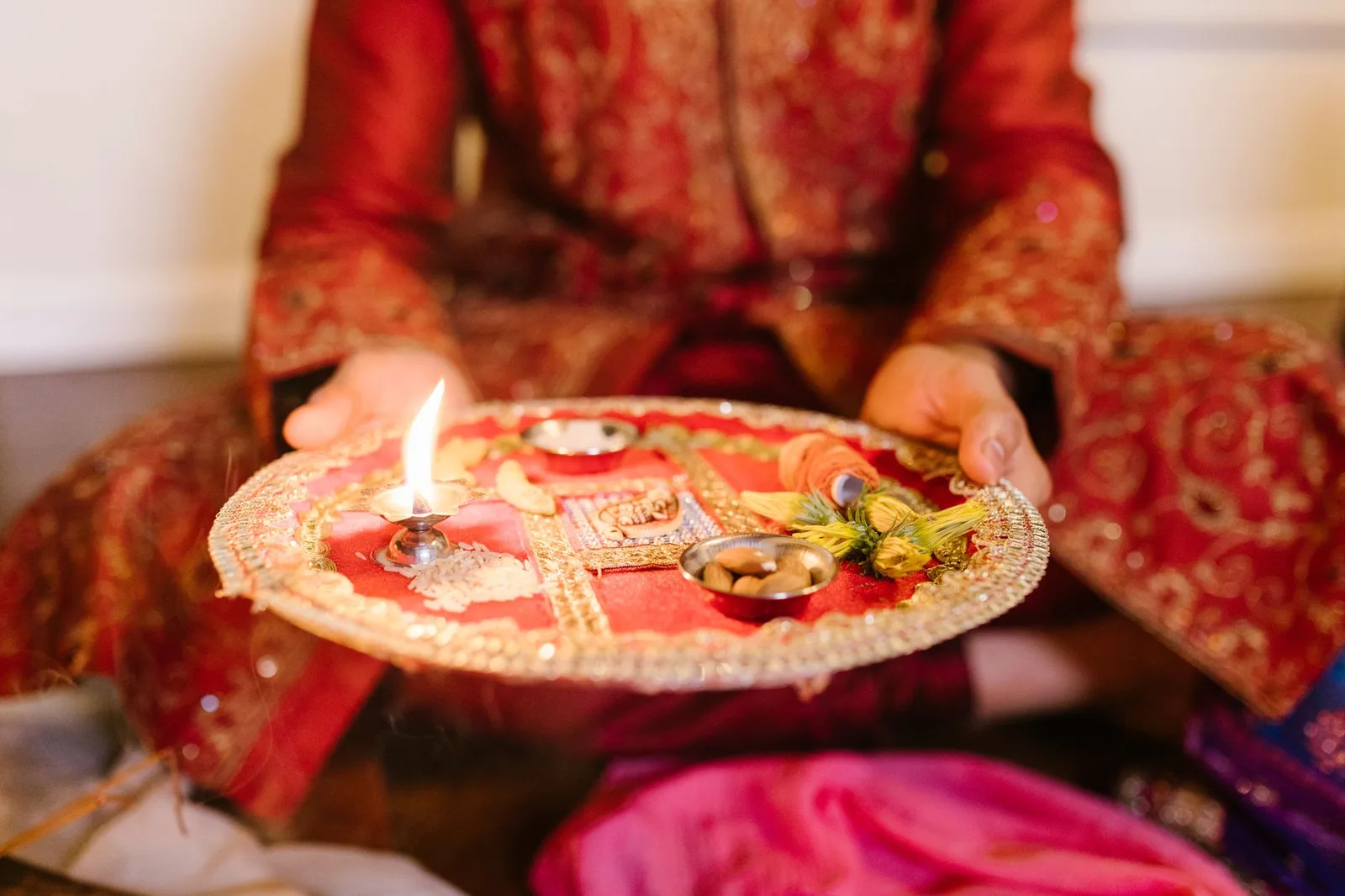 Close-up of a decorated puja thali with a lit diya, symbolizing Diwali celebrations.