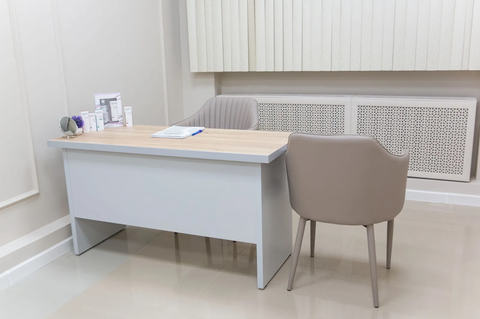 Minimalist medical office with a modern desk and chairs, perfect for healthcare settings.