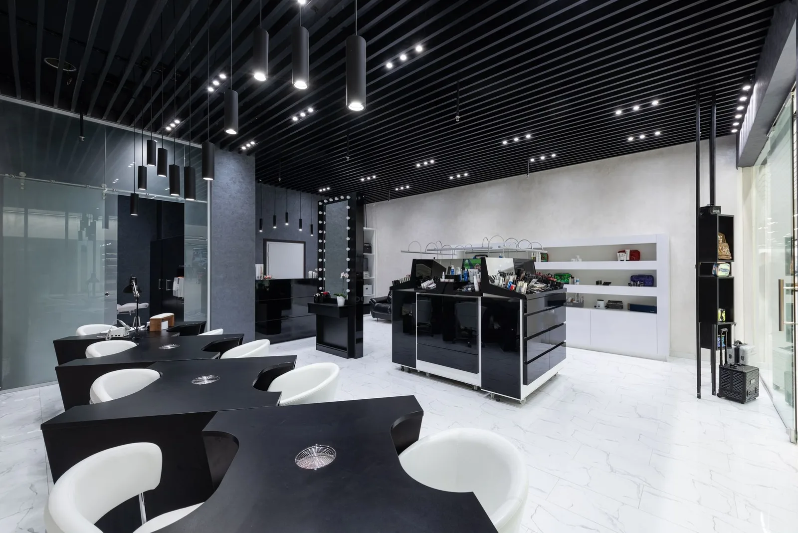 Sleek beauty salon interior with contemporary furniture and lighting design.