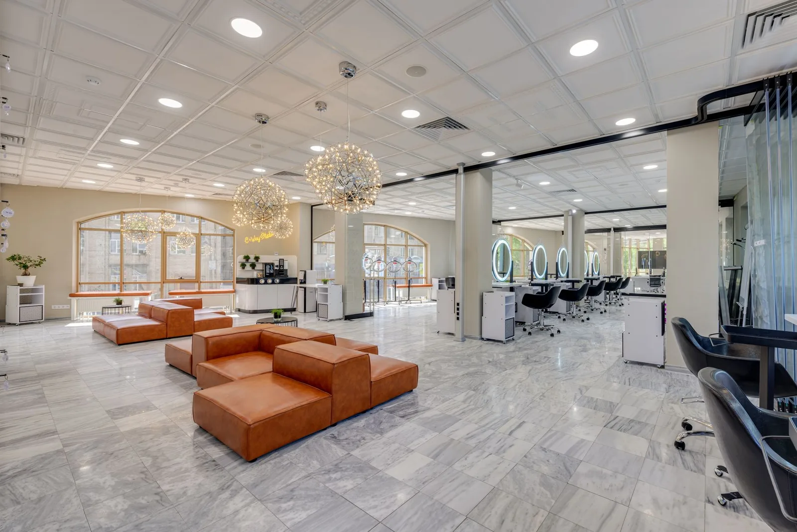 Elegant and cozy modern salon with ample natural light and stylish decor.