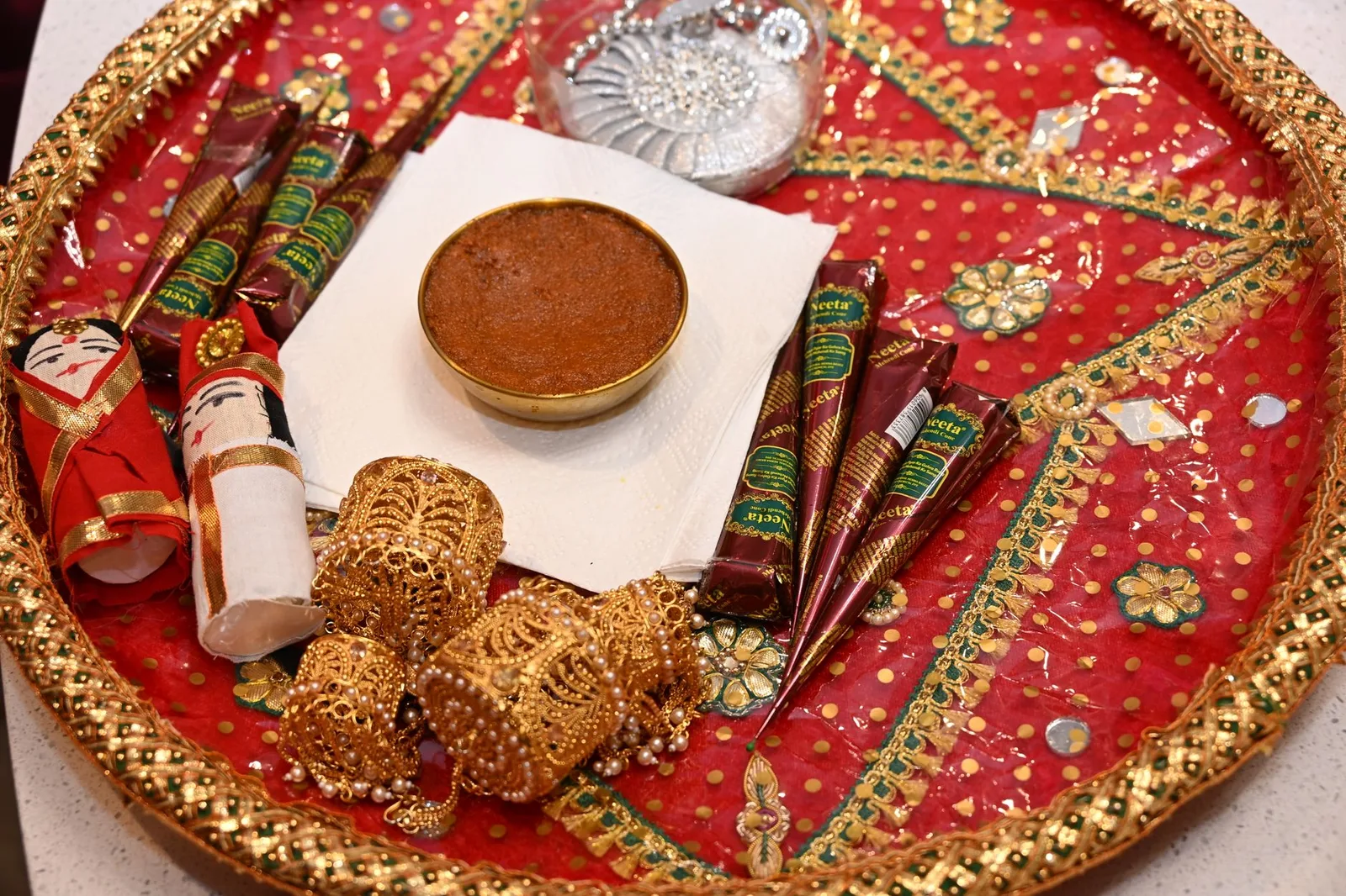 A traditional Indian puja thali with decorative items and offerings for religious rituals.